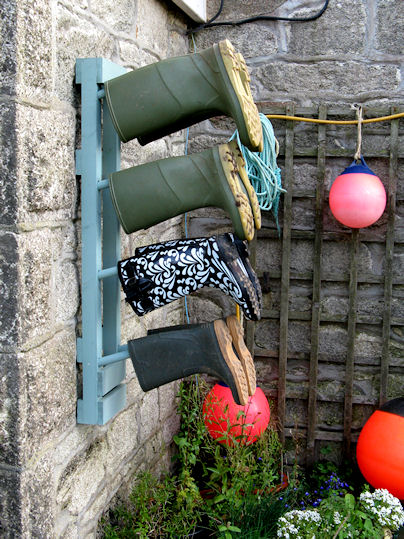 Wall mounted welly rack, outdoors. 